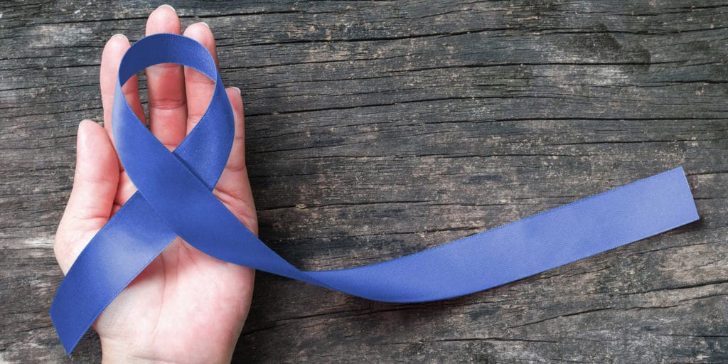 a person holds a ribbon and celebrates addiction recovery rewards
