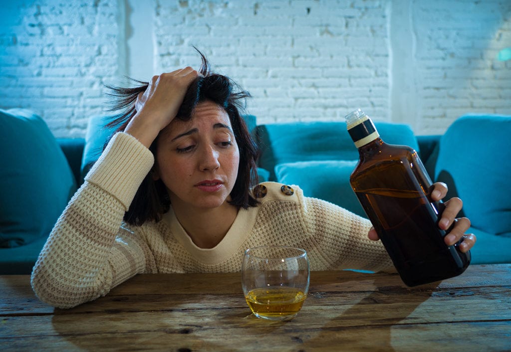 woman drinking and wondering why is alcohol addictive